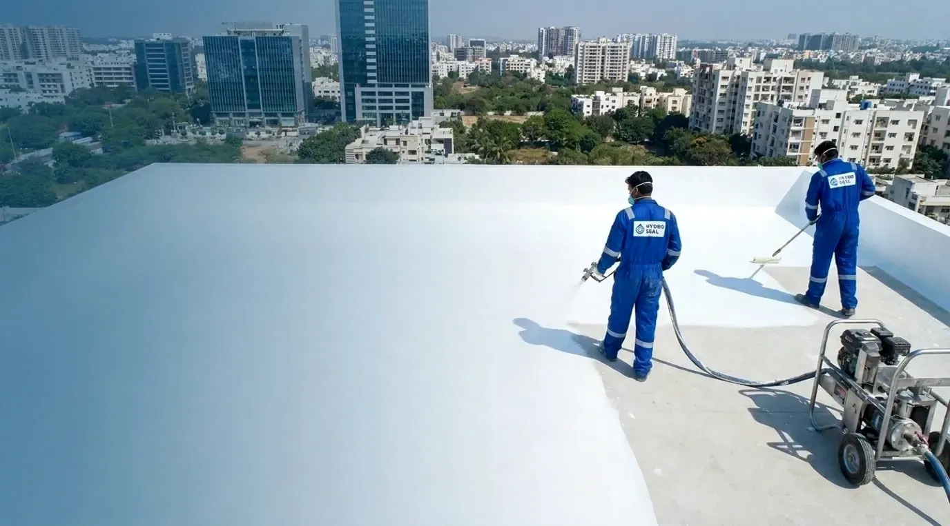 Hydroseal technicians applying terrace waterproofing coating in Hyderabad
